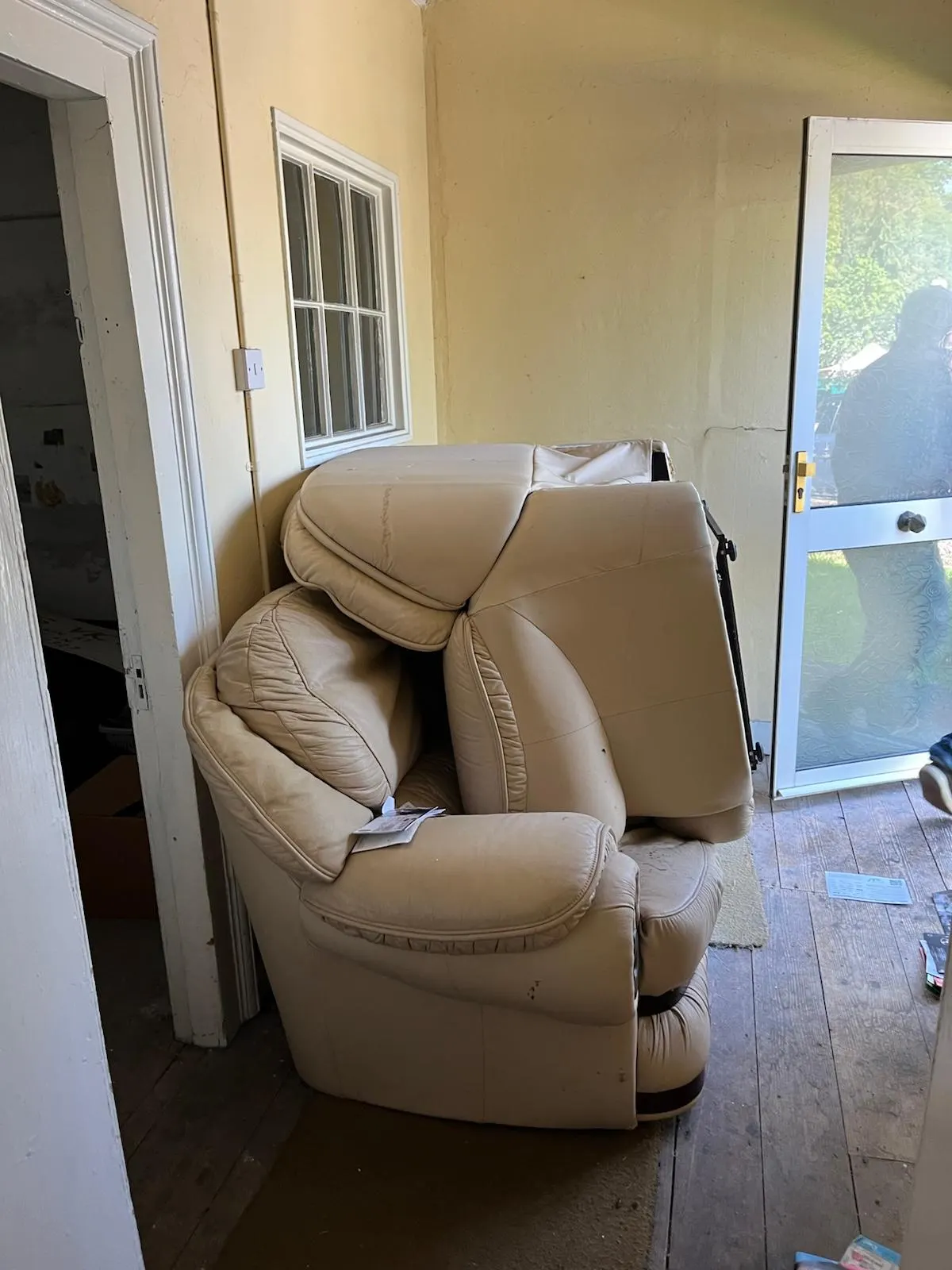 Unwanted leather seating in a room before furniture collection