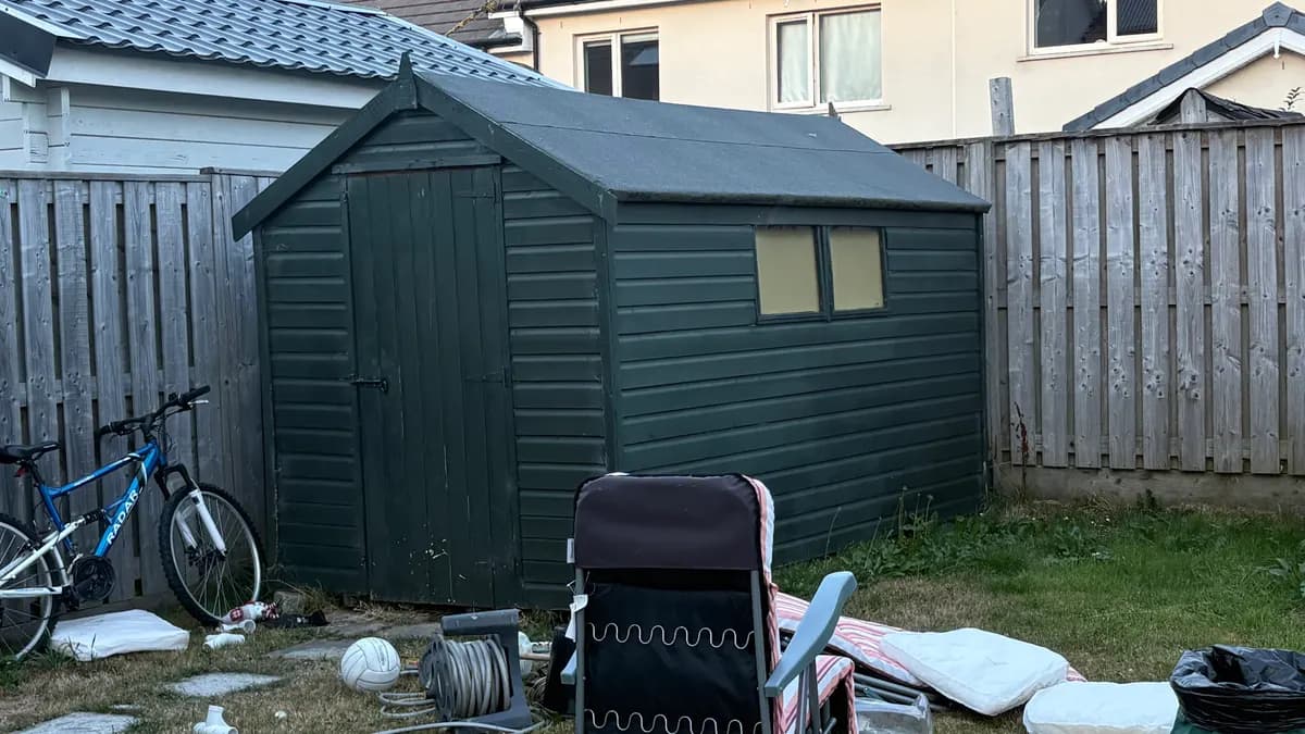 Timber shed and unwanted garden items photographed before collection